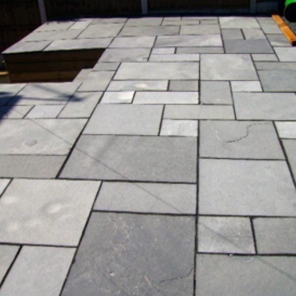 Faded black limestone paving - The sun's UV light has bleached the stone's pigment.