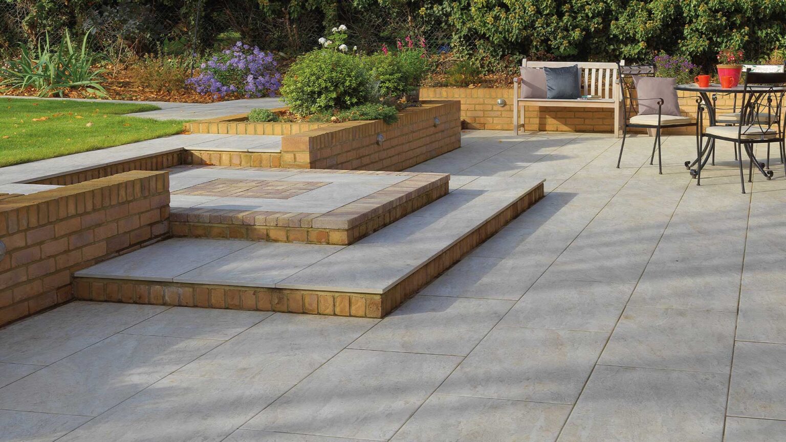 Yellow stock parapet retaining walls with a Dolomite Dust porcelain terrace & steps.