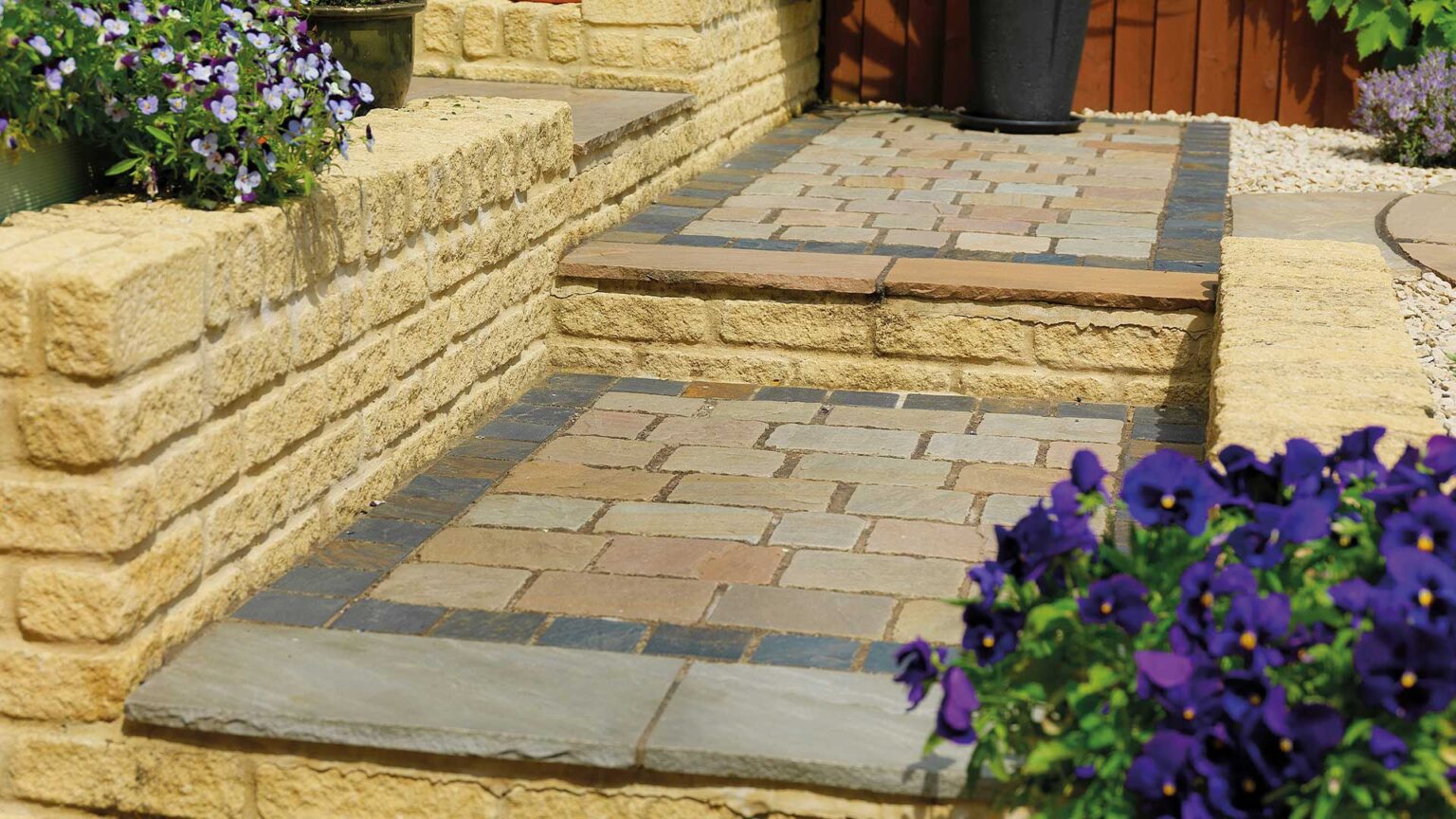 Tumbled Bekstone Golden Buff walling with Raj Blend steps and setts, with a midnight slate picture frame in-lay course.