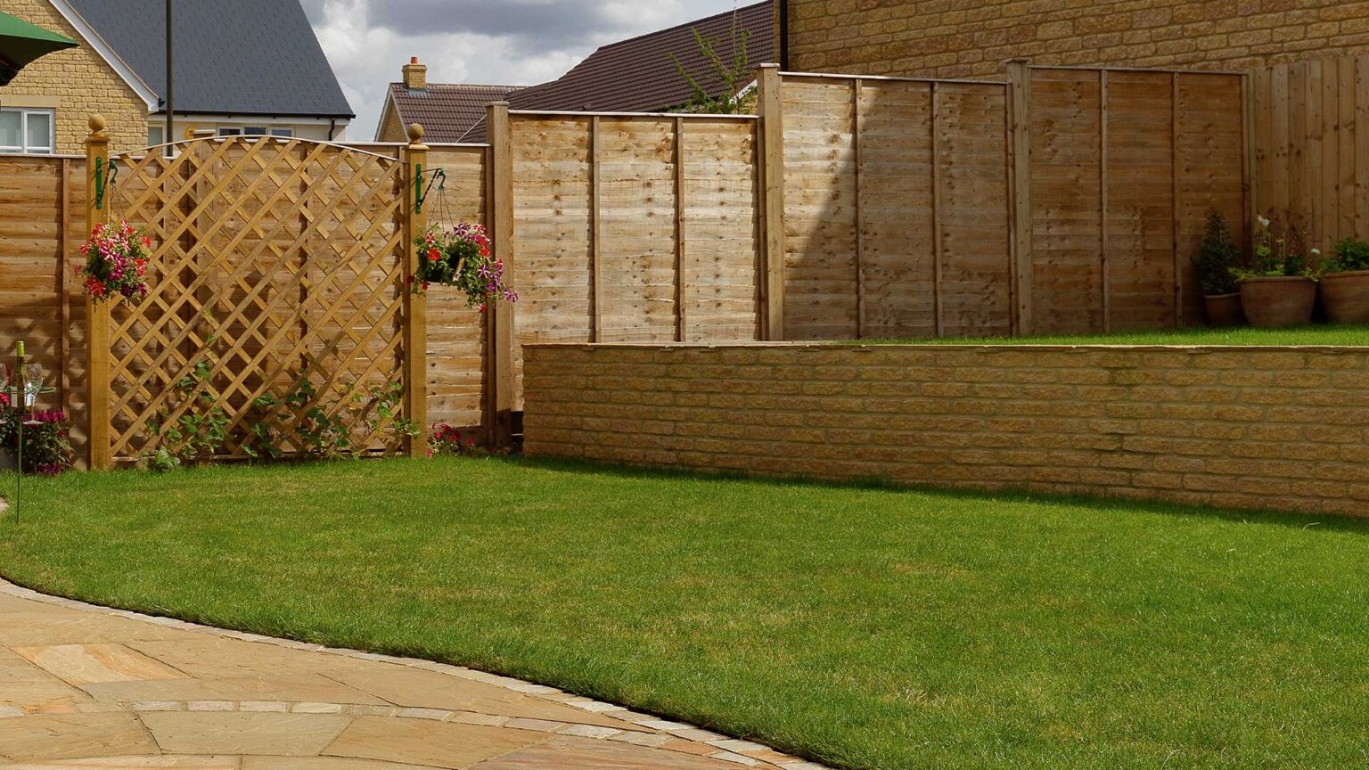 A terrace retaining wall using single course-height blocks (229 x 65 mm and 305 x 65) Golden Buff tumbled walling blocks.