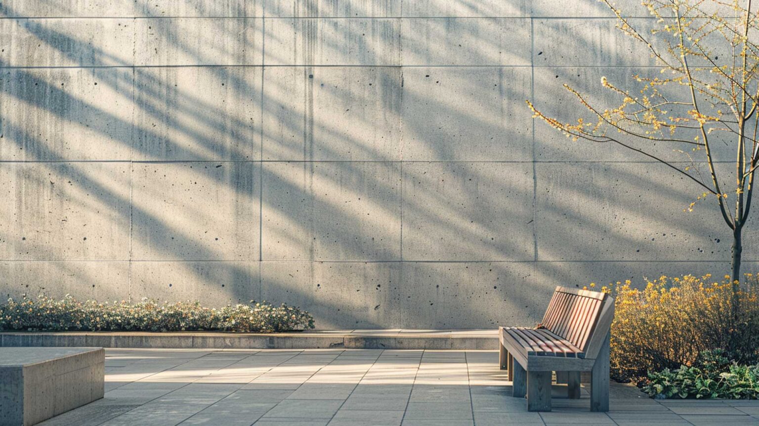 This large retaining wall has a facade of honed concrete blocks, creating a sense of scale and proportionality.