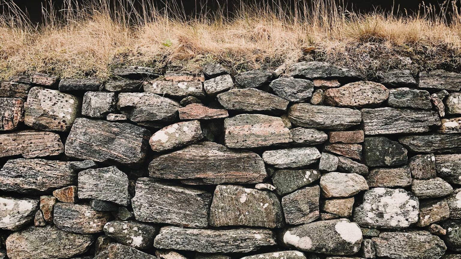 Notice the sedimentary striations akin to wood grain in this limestone dry stone wall and the role of lichen and black spots have adding charm.