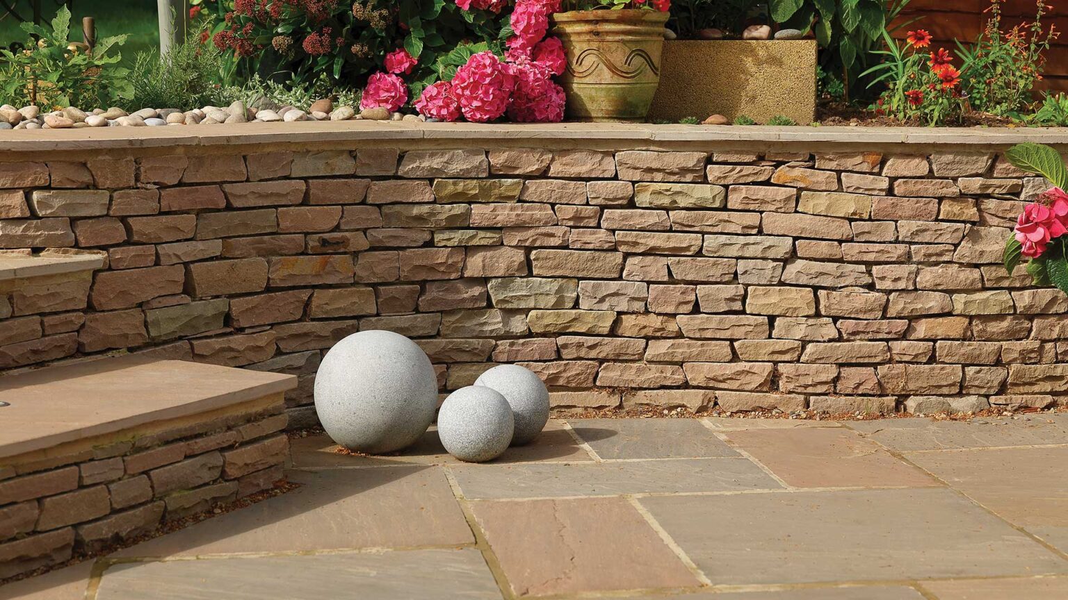 A dry stone facade of Raj Blend sandstone on this dwarf retaining wall.