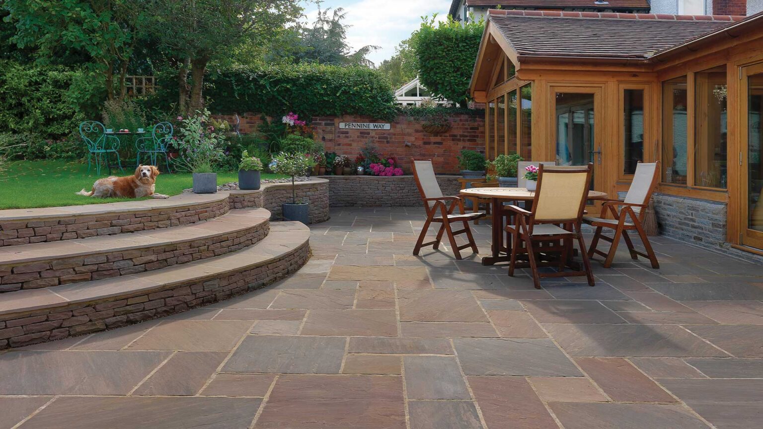 Broad sweeping steps and an terrace retaining wall with matching dry stone Raj Blend facade on the step risers and wall.