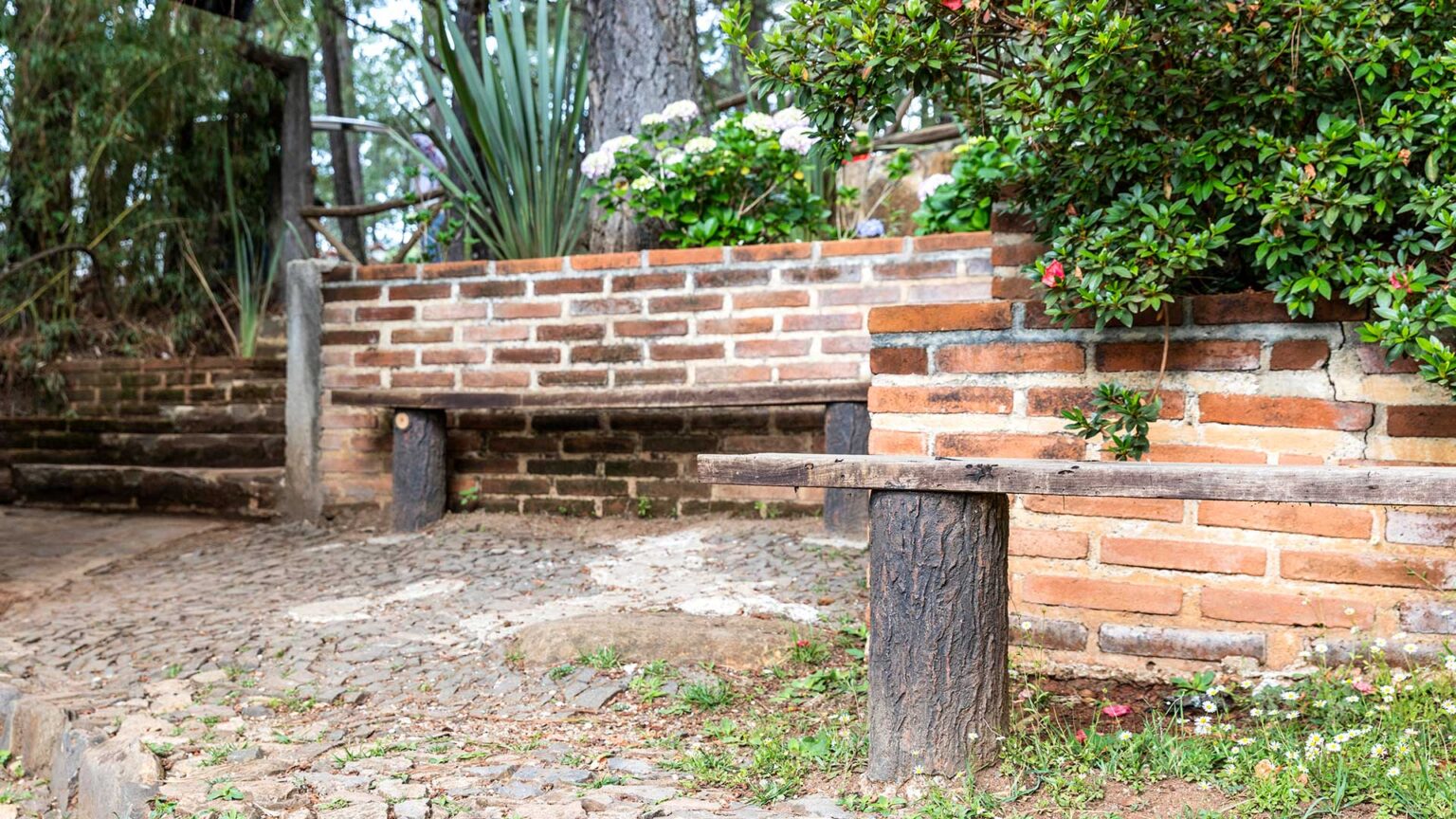 A red brick dwarf wall retaining raised beds. Note the low profile of these bricks - akin to Tudor period ones