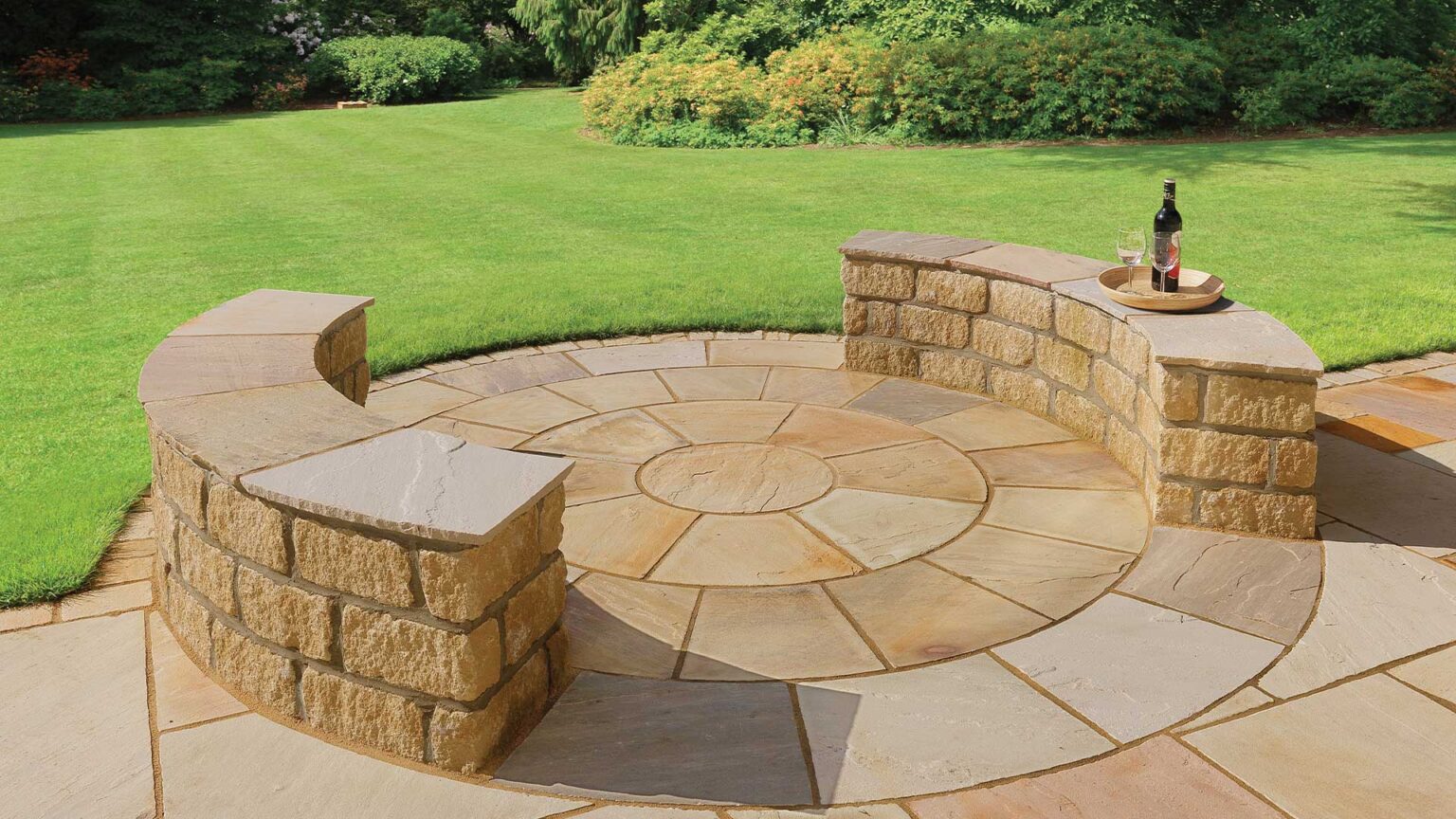 Large reconstituted stone tumbled block have been used to create this feature's quarter-circle seating walls.