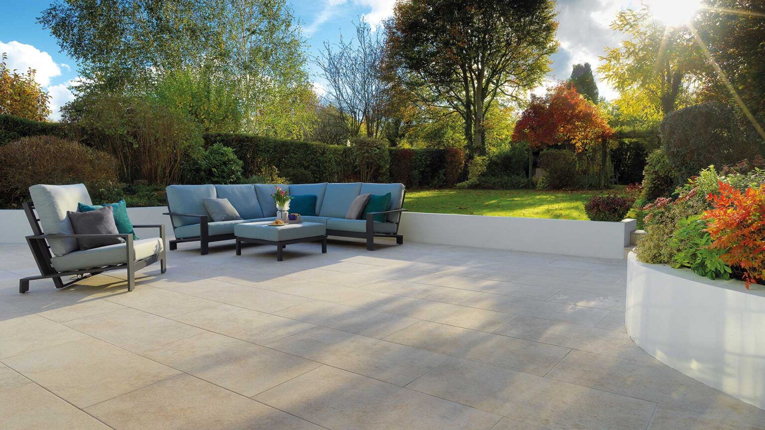 A white rendered parapet wall (with raised bed) surrounding a graceful patio