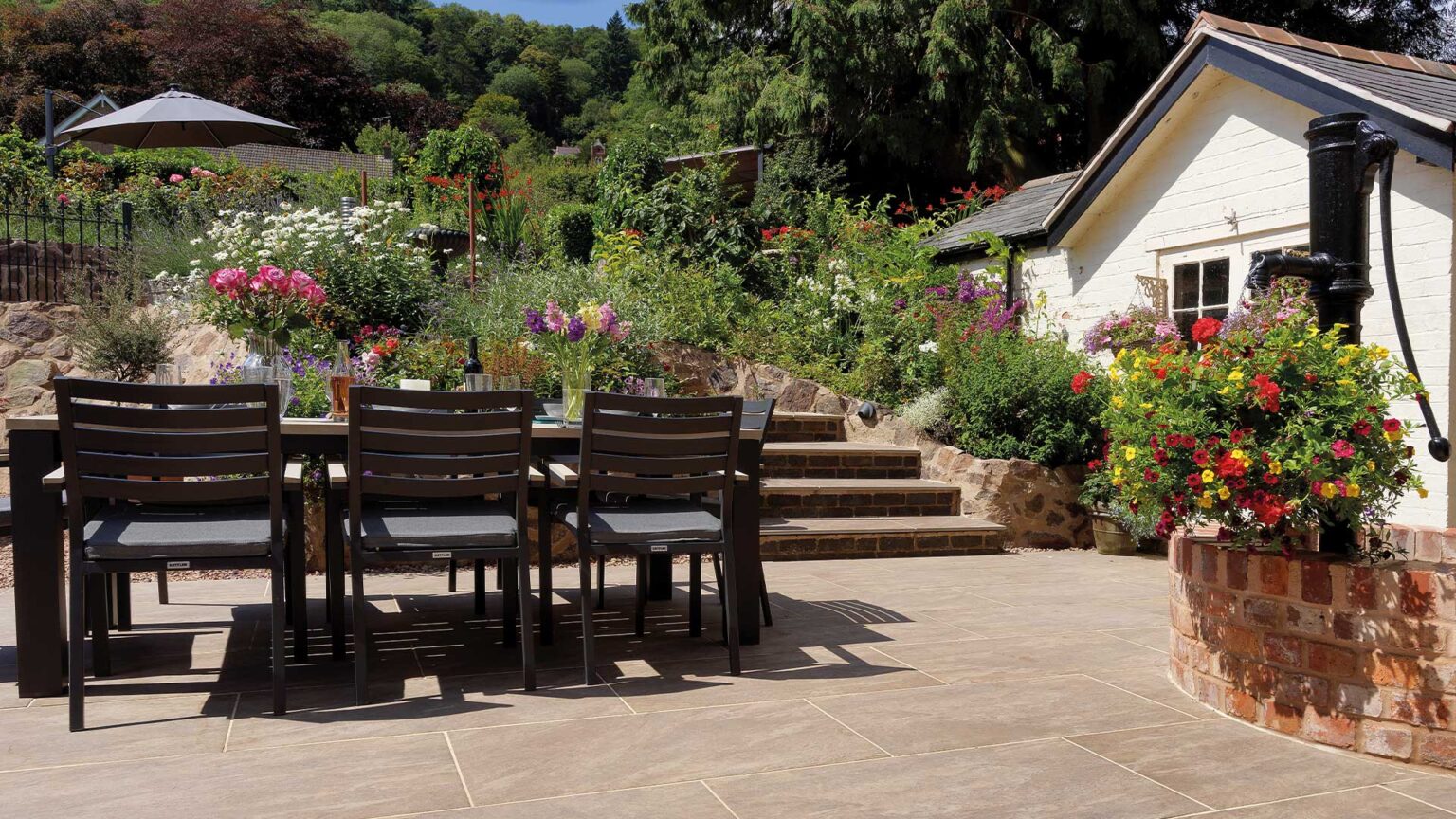 Dolomite Sunset porcelain slab steps with red facing bricks on the lifts of the garden patio steps.