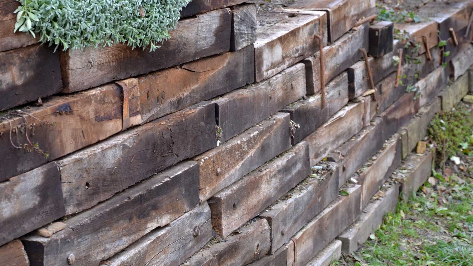 Old timber sleepers are used here to retain raised garden beds for a rustic, shabby-chic type appearance.