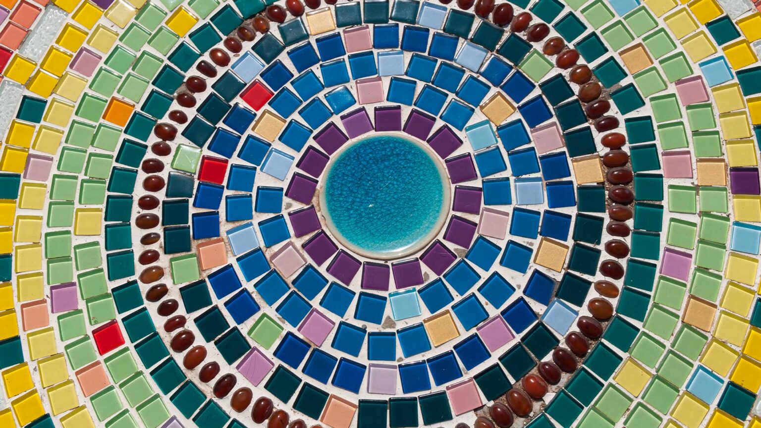 A mosaic circular feature made with small coloured glass tiles.