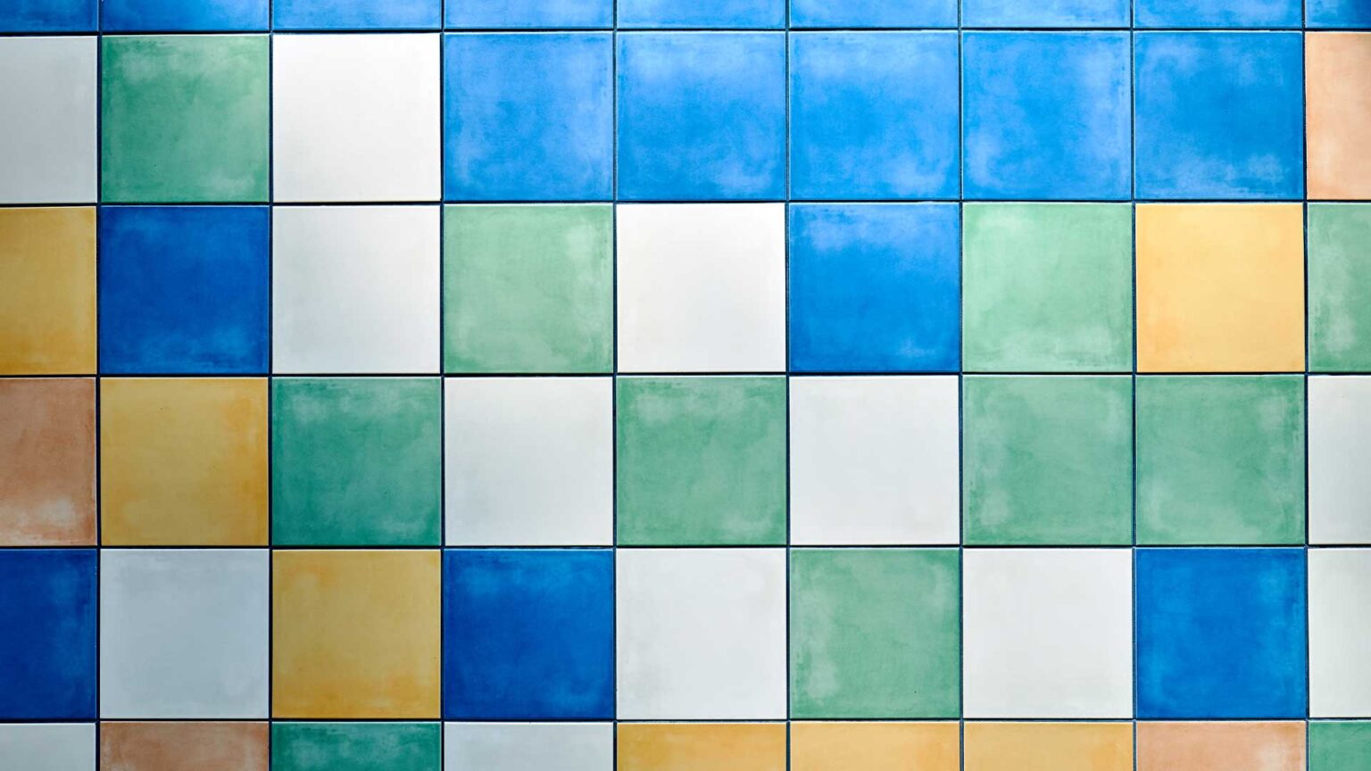 Mixing glazed tiles to create an abstract pattern that is colourful and slightly irreverant.