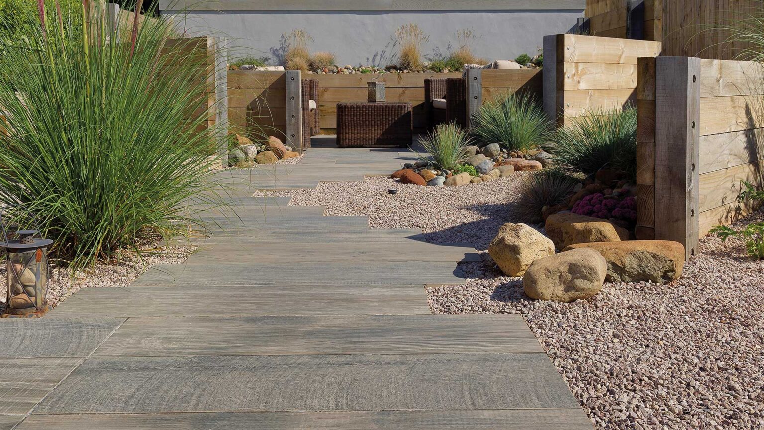 Sleepers used here to create both raised beds and wind breaks in this coastal garden.