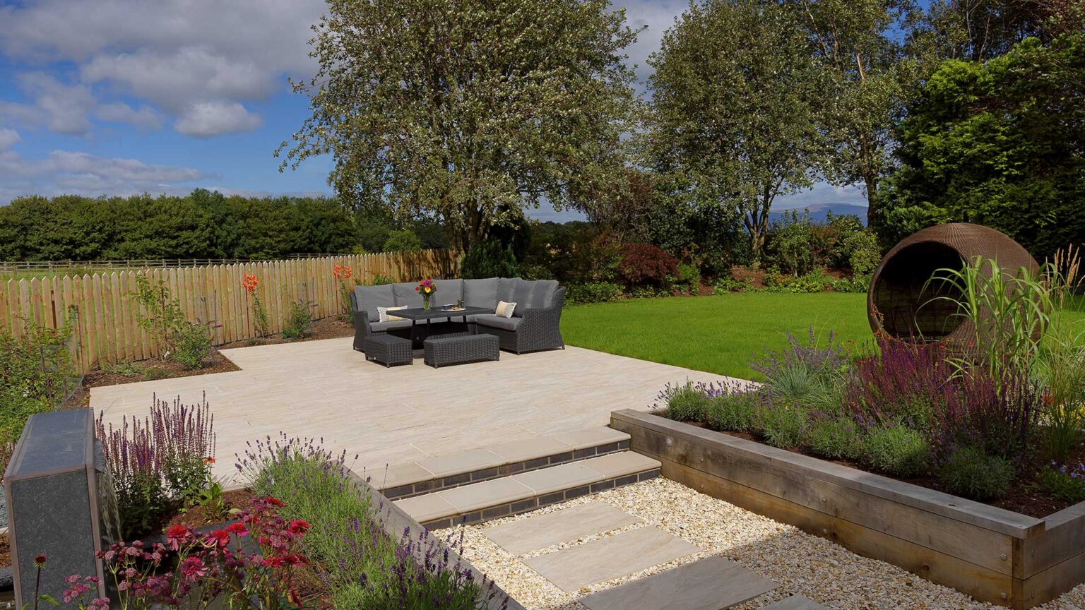 Timber planks bolted and braced together to create the retaining walls of the raised beds of this contemporary style garden.