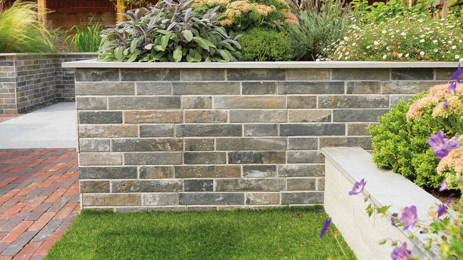 A raised bed dwarf wall with porcelain brick cladding facing & porcelain tile coping stones