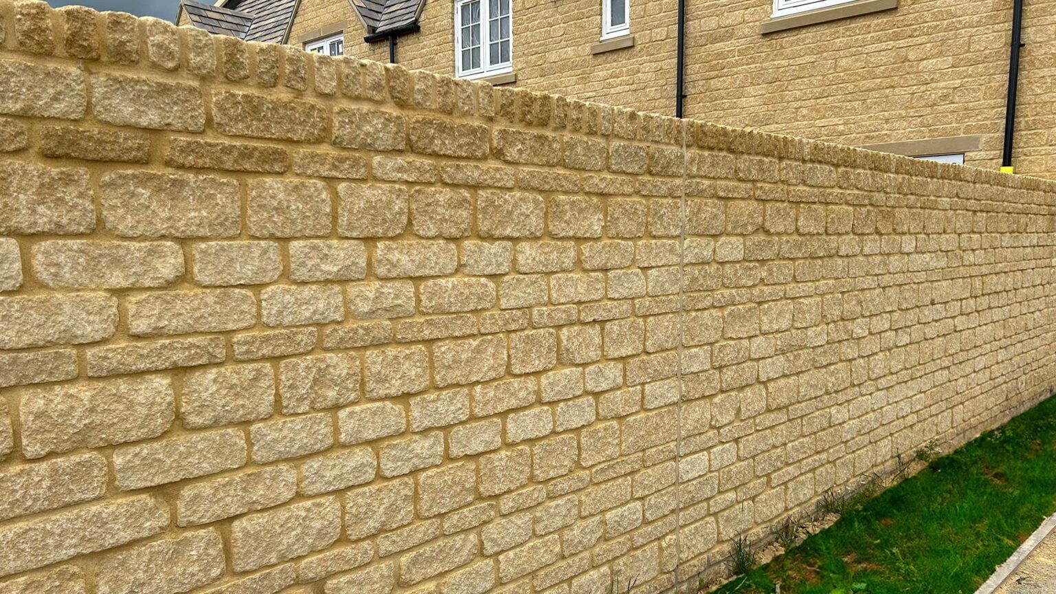 A tumbed stone wall using Bekstone Golden Buff Walling to match the house of the same blocks.